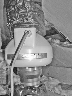 A fan in the attic pulls air from beneath the basement floor up and out through the roof.
