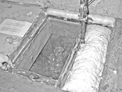 Pit in basement floor.