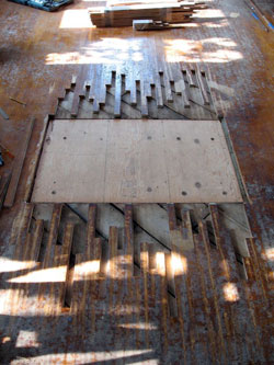 After selectively removing boards to stagger the patch, the area is ready for installation of reclaimed maple flooring.