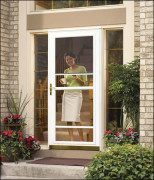 photo of white ventilating storm; woman in doorway. 
