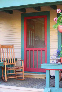 photo of red painted door with aqua door trim.