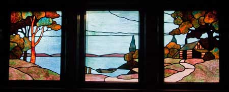 These windows are in a 1920s bungalow across the alley from the duplex. Although the visual elements are similar to the above set (house, lake and boat), there are differences. Note also that the windows themselves are a different shape—the bungalow windows are rectangular with a vertical orientation; the duplex windows are square.
